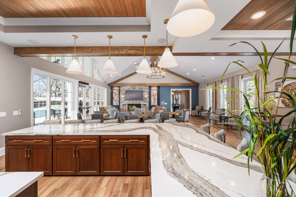 Modern commercial clubhouse bar and lounge featuring marble counter tops, plush seating and large windows at The Landings Clubhouse.