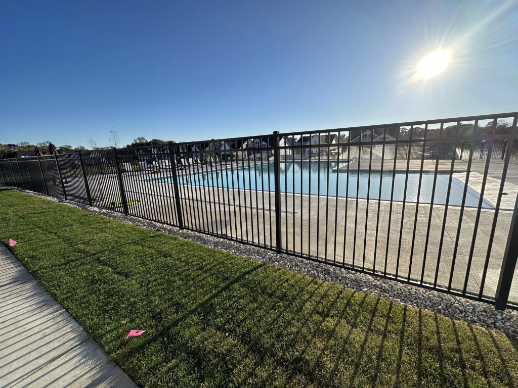 Modern Towerhill Clubhouse exterior design featuring a swimming pool and metal fencing by Wade Architecture.