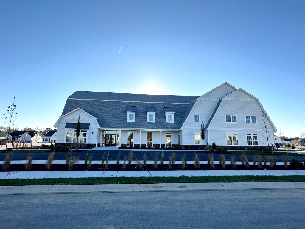 Modern commercial building exterior design with dormer windows and stone accents by Wade Architecture.