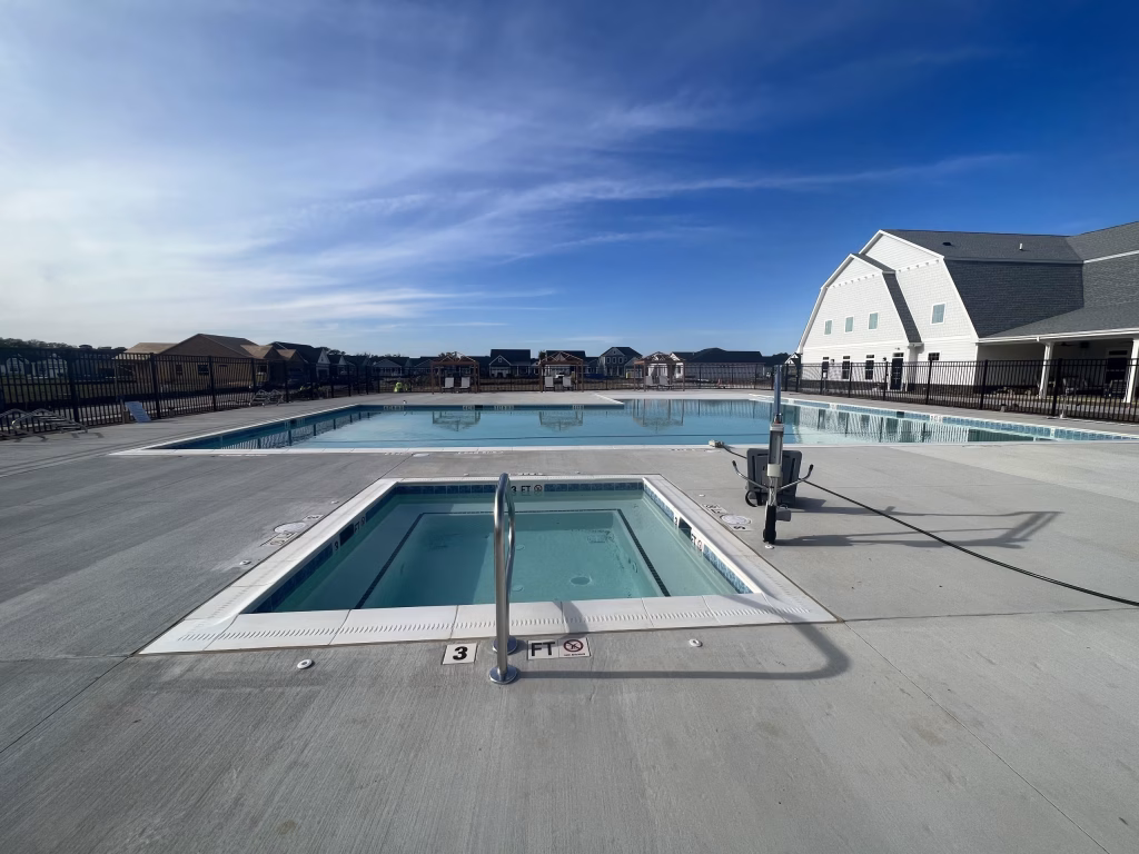 Modern commercial clubhouse exterior design featuring a pool and hot tub by Wade Architecture.