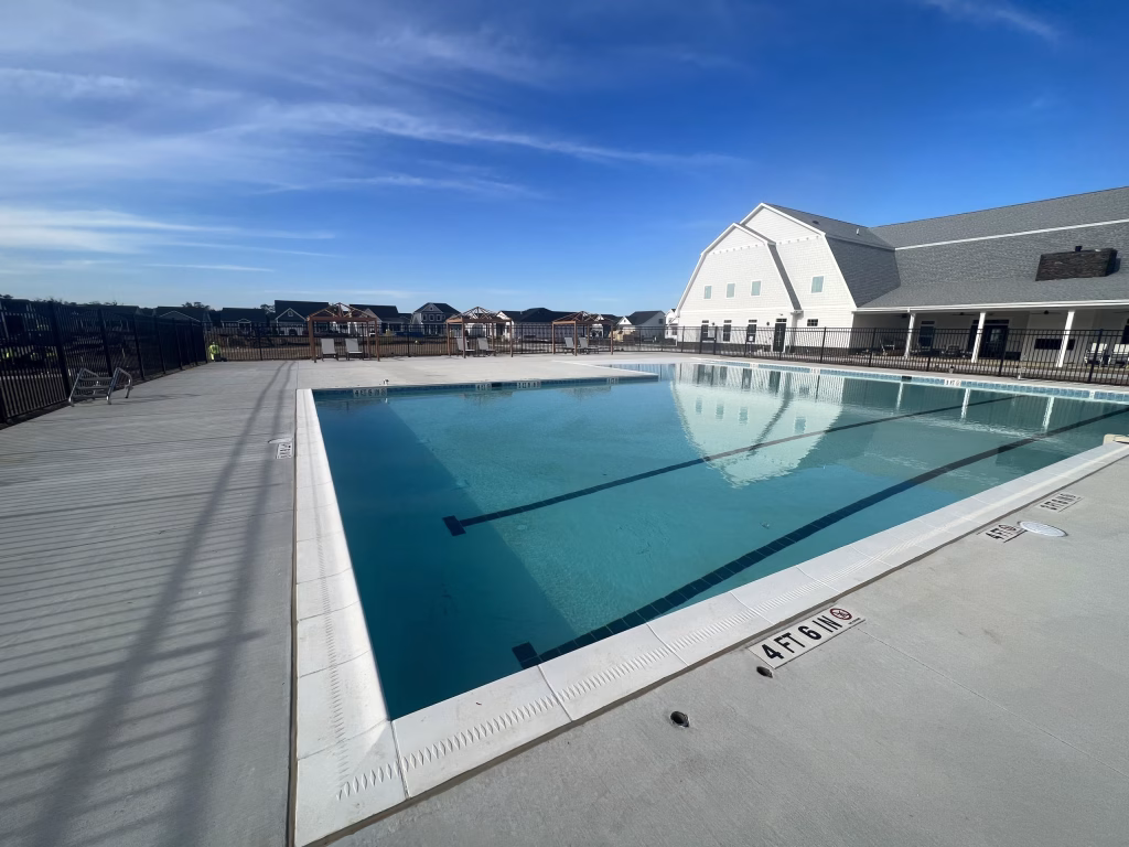 Towerhill Clubhouse exterior featuring an outdoor pool and patio in Lewes, DE.